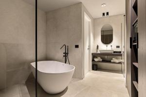 a bathroom with a white tub and a sink at Dimora degli archi in Terrasini +25 photos