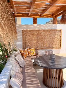 a patio with a couch and a table at Apademia Comfort Studio 45 sqm in Skiros
