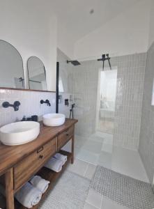 a bathroom with two sinks and a shower at Suite privée charentaise in Romegoux