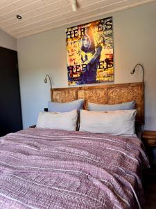 a bedroom with a large bed with a purple comforter at Luxus Kutsche in Grafengehaig