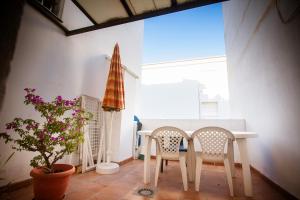 a dining room with a table and two chairs at MAQUINILLA PORTAL 4A in Nerja