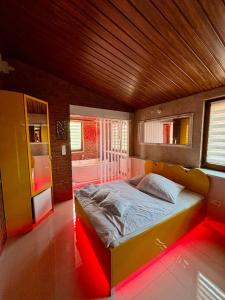 a bedroom with a large bed with a red light at Apartament "Loft Love" Jacuzzi SPA z dużą wanną z hydromasażem dla Dwojga in Gniezno +12 photos