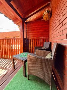 a patio with a table and chairs on a deck at Apartament "Loft Love" Jacuzzi SPA z dużą wanną z hydromasażem dla Dwojga in Gniezno