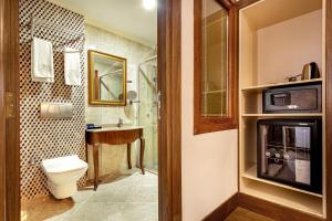 a bathroom with a toilet and a sink and a shower at The central hotel in Istanbul