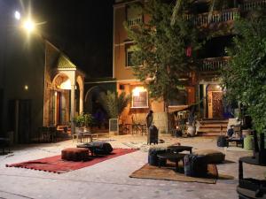 a courtyard of a building at night at Riad Perlamazigh in Zagora