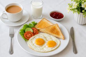 a plate with eggs and toast and a cup of coffee at IBEX COTTAGE SHARDa in Shardi