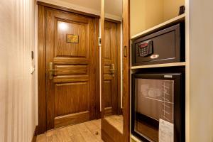 a hallway with a door and a television in a room at The central hotel in Istanbul