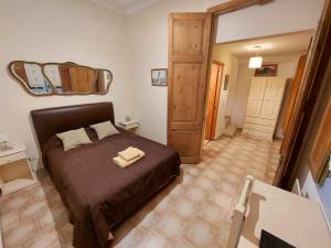 a bedroom with a bed with two towels on it at La Querencia de Buenos Aires in Buenos Aires