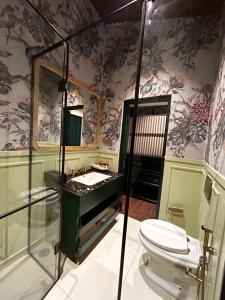 a bathroom with a toilet and a sink and a shower at MONKEY RESORT in McLeod Ganj