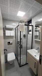 a bathroom with a shower and a toilet and a sink at Nergiz Boutique Hotel in Antalya