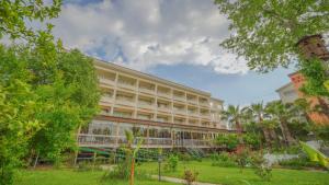 a large building with trees in front of it at Bieno Venüs Hotel - All Inclusive in Side