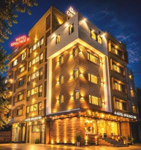 a hotel building with lights on it at night at Opulence Inn - 500 Meters From Railway Station in Udaipur
