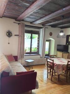 a living room with a couch and a table at Studio La Grenouillère in Turckheim
