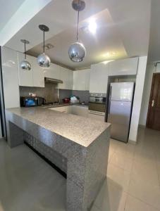 a kitchen with a granite counter top in the middle at Blumar El Sokhna in Ain Sokhna