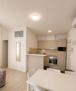 a kitchen and living room with a white table at Aparthouse Penelope in Supetarska Draga +41 photos