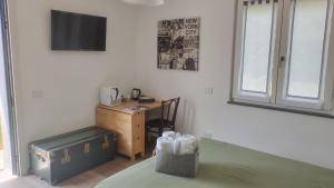 a bedroom with a desk and a bed and a desk with a chair at Bobbio Relax in Bobbio