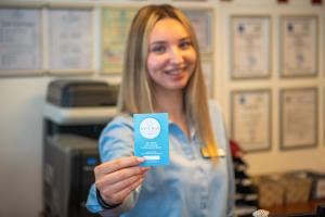 a woman holding a card in her hand at Safir Blue Resort in Saturn