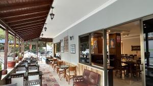 a restaurant with a bunch of chairs and tables at Yağmur Apart Otel in Didim