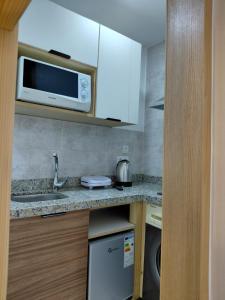 a kitchen with a sink and a microwave at Studio cozy 04 in Tangier