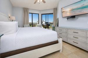 a bedroom with a bed and a flat screen tv at Phoenix X 101 in Orange Beach +46 photos
