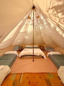 a canvas tent with two beds in it at La Veleta Cádiz in Cádiz