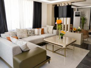 a living room with a couch and a table at Nergiz Boutique Hotel in Antalya