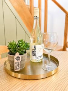 a bottle of wine and a glass on a table at Lugas Apartman in Harkány