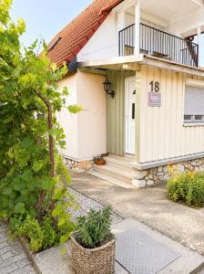 a house with the number on it at Lugas Apartman in Harkány