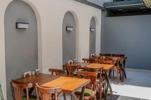 a row of wooden tables and chairs in a room at Nergiz Boutique Hotel in Antalya +24 photos