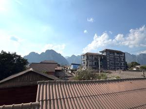 a view of a city with buildings and mountains at BON Premier Boutique Hotel in Vang Vieng
