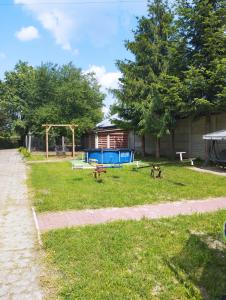 a park with a picnic table and a playground at Domki pod brzózkami in Bodzentyn