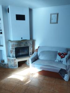 a living room with a couch and a fireplace at Domki pod brzózkami in Bodzentyn