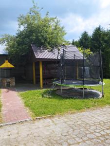 a batting cage in front of a house at Domki pod brzózkami in Bodzentyn