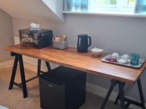 a wooden table with a microwave on top of it at White Quarry Hse Quarry Road in Navan +26 photos