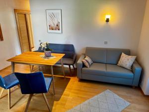 a living room with a couch and a table at Landhaus Zoppoth in Kötschach