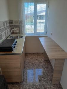 a kitchen with a sink and a window at Guest house Tea in Kvareli