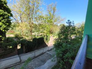 a view of a garden from a balcony of a house at Galamb Odú Apartman in Baja