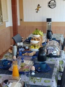 a table topped with plates and bowls of food at B&B Casa Flamenga in Alte