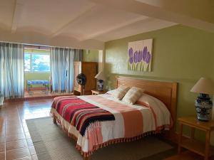 a bedroom with a bed and a large window at Casa Zuniga Extended Stay in Guanajuato