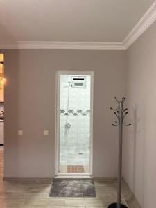 a white room with a glass door and a metal pole at Vacation Home Nukri in Gonio +61 photos