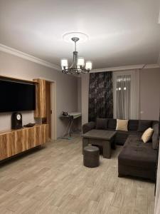 a living room with a couch and a flat screen tv at Vacation Home Nukri in Gonio