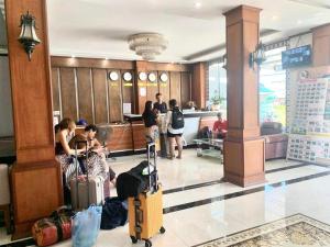 a group of people standing in a lobby with luggage at BON Premier Boutique Hotel in Vang Vieng +47 photos