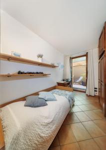 a bedroom with a bed with two pillows on it at Mella Bellagio Al Porto - Apartment with terraces near the Lake - Parking in Bellagio