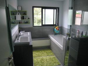 a bathroom with a sink and a tub and a window at Villa proche de Bordeaux in Gradignan +12 photos