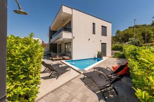 a villa with a swimming pool and a house at Villa Nika with pool & parking near Zadar in Bibinje