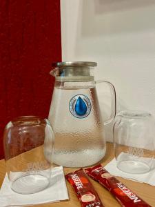 a jug of water and a glass jar of sugar at 'MONAS' mini apartments in Sombor