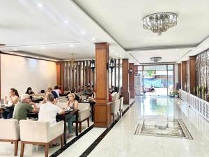 a restaurant with people sitting at tables at BON Premier Boutique Hotel in Vang Vieng