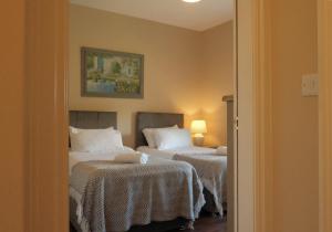 a hotel room with two beds and a mirror at Flat 4, 2 Victoria Street in Armagh