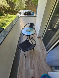 a small table and chair on a balcony at N'Shkoder in Shkodër