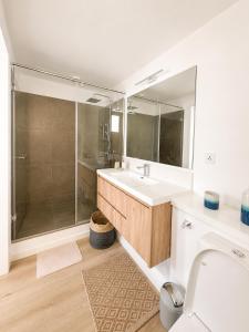 a bathroom with a shower and a sink and a toilet at Blue Zebra - Le West 24 in Tamarin
